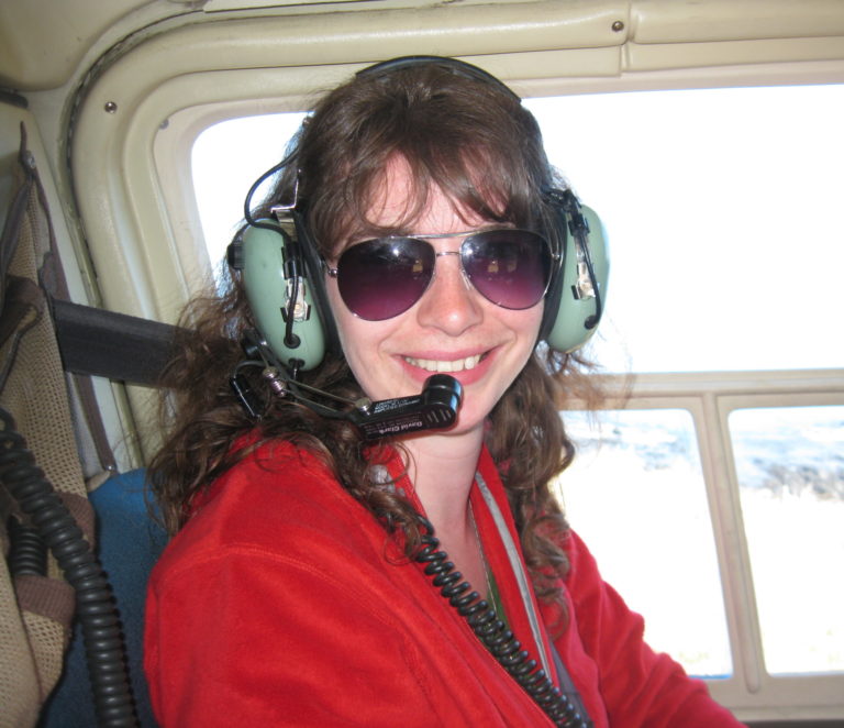 Debbie sitting shotgun in a helicopter